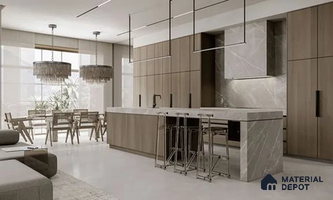 a kitchen with marble counter tops and wooden cabinetry, along with an island in the middle of the middle of the island with stairs leading to shop & more counter top space to an island in the middle of